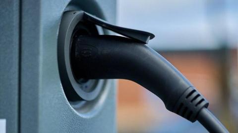 Close up of an electric vehicle charger.