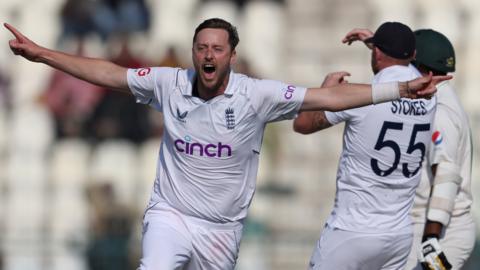 England bowler Ollie Robinson runs away in celebration after taking the final wicket