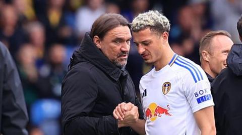 Ethan Ampadu comes off and embraces Leeds United boss Daniel Farke