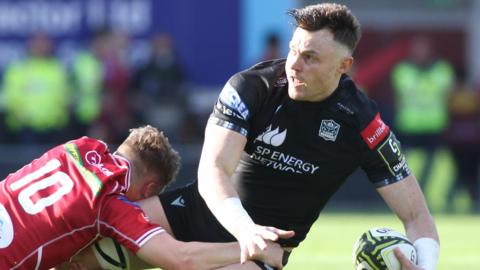 Glasgow's Jack Dempsey is tackled by Scarlets fly-half Sam Costelow