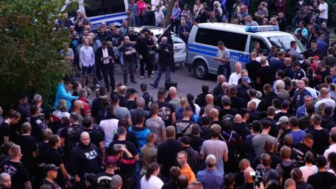 People gather in the German city of Köthen after a 22-year-old man died following a street fight, 9 September 2018