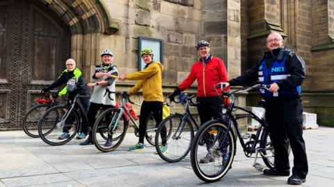 Cyclists outside Newcastle Cathedral