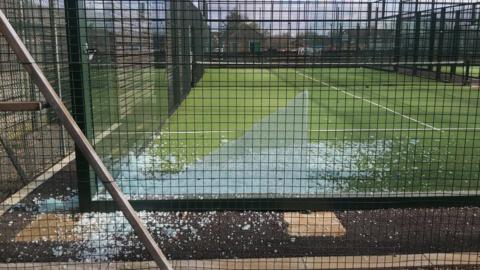 Shattered glass on the floor and on the padel court