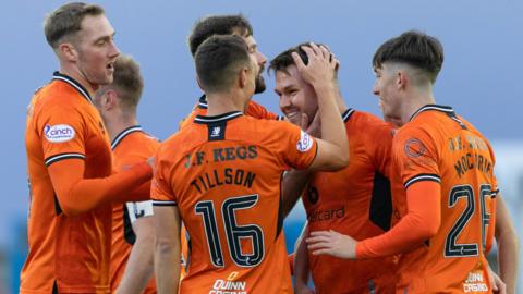 Dundee United's Glenn Middleton celebrates making it 1-0 with his teammates during a SPFL Trust Trophy match between Peterhead and Dundee United at Balmoor Stadium,