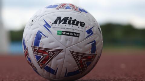 A National League football on an athletics track