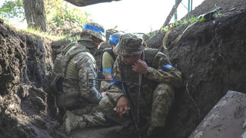 Ukrainian servicemen hide from shelling, amid Russia's attack on Ukraine, near the Russian border in Sumy region