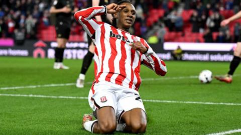Lamine Cisse slides on his knees and salutes the Stoke City fans