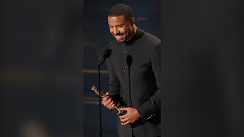 Michael B Jordan is seen holding an Oscars.