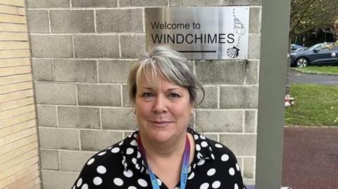 Carrie Wood, founder of SNAAP, stands outside their home building - Windchimes in Herne Bay.