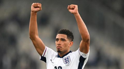 Jude Bellingham holds his fists in the air to celebrate an England victory against Greece in November 2024