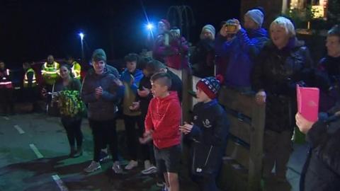 Crowds watch as the runners are revealed