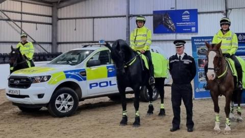Dorset police mounted volunteers with police cars
