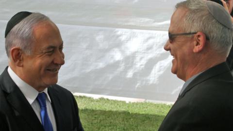 Benjamin Netanyahu shakes hands with Benny Gantz at Mount Herzl in Jerusalem on 19 September 2019