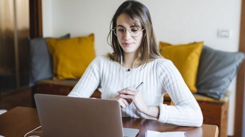 Young woman watching an online course