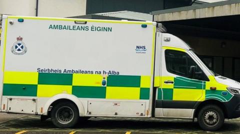 Ambulance with green and yellow checked markings