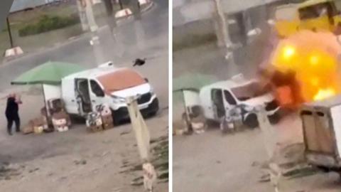 Man dressed in black chased by a black drone as he runs close to a white van and a green parasol on a dusty bit of ground alongside a road. The same scene to the right shows a ball of flame as the drone explodes.