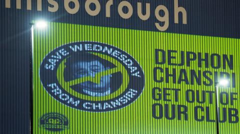 An image of former Sheffield Wednesday owner Dejphon Chansiri projected onto the side of Hillsborough by fans calling for him to go