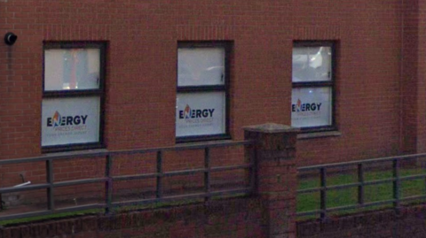 A red brick building with tinted windows saying Energy Prices Direct Limited on them