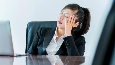 Woman falling asleep in meeting