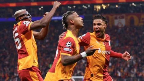 Galatasaray players celebrate scoring against Liverpool in the Champions League
