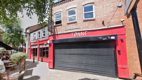 The front of Tonne Bar with shutters down in the daytime