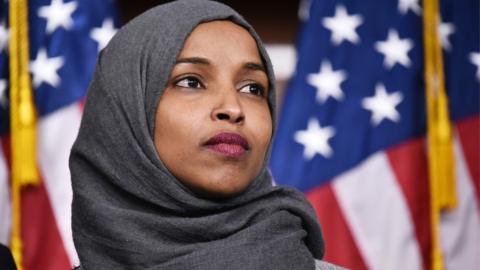 Congresswoman Ilhan Omar in front of US flag