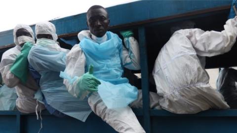 Dozens of volunteers like Jibrila Sesay are playing a central role in the gruesome clear-up operation