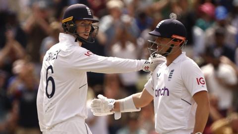 Zak Crawley (left) and Alex Lees (right) celebrate reaching a century stand against India