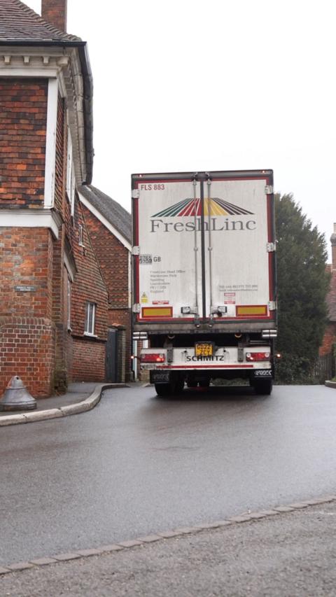 A lorry driving down a narrow road