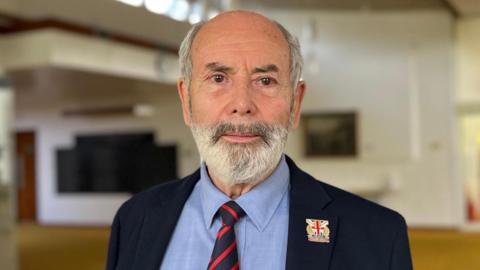 A man in a jacket and tie