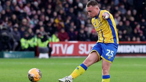 Louis Reed striking and scoring a right-footed effort for Mansfield Town