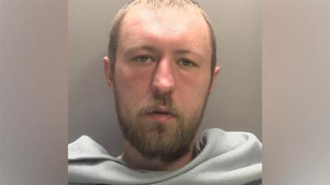 A mugshot of John Ashby