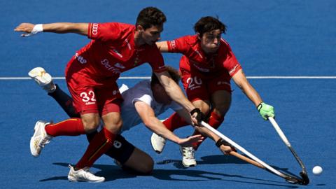 Jacob Draper of Great Britain is tackled by William Ghislain and Tanguy Cosyns of Belgium