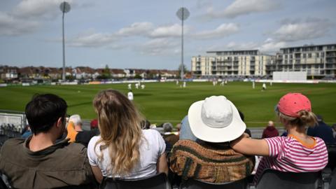 Cricket fans watch Gloucestershire play Yorkshire at the county ground in Bristol