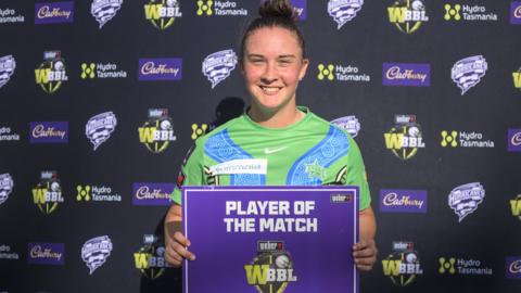 Alice Capsey receiving a player of the match award from the Women's Big Bash League