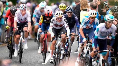 The peloton passes through a town centre on stage one of the 2024 Lloyds Bank Tour of Britain Men in Kelso in the Scottish Borders.