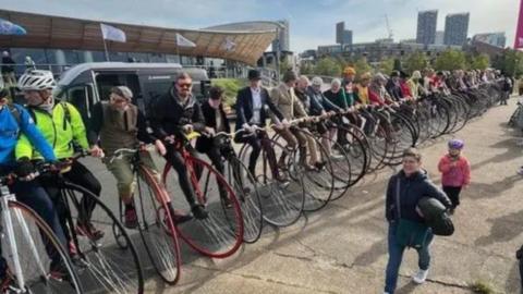 A long line of penny farthing riders in London completing the stack.