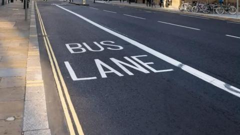 A generic image of a road with the words "Bus Lane" in large white letters