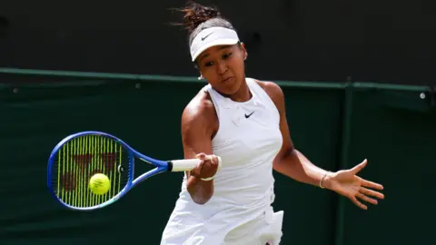 Naomi Osaka hits a forehand
