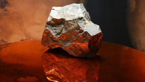 A grey-coloured Mars rock sits on podium