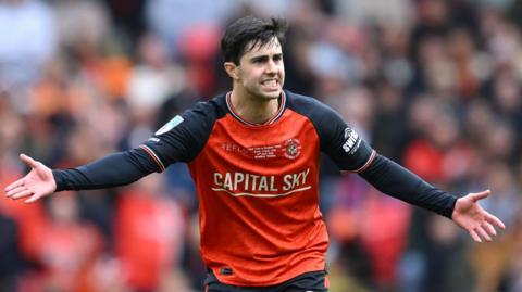 Luton Town midfielder Liam Walsh gesticulating with his arms out wide