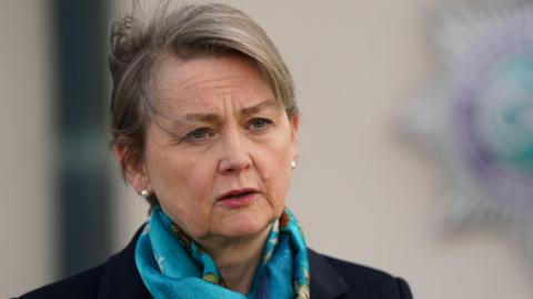 Home Secretary Yvette Cooper - a woman with short blonde hair, wearing a blue scarf and a black coat.