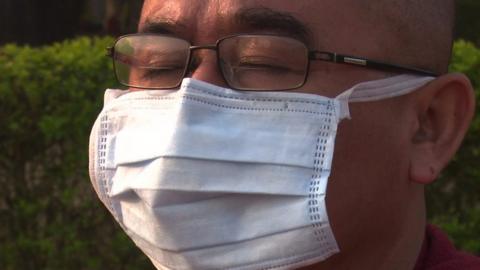 A Buddhist monk wearing a mask in Lumbini