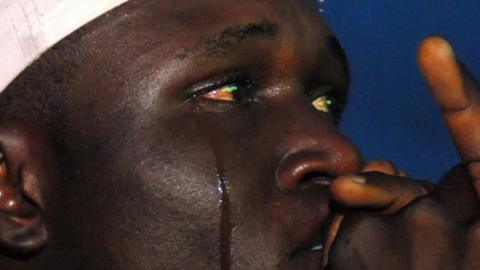 A Nigerian football fan cries