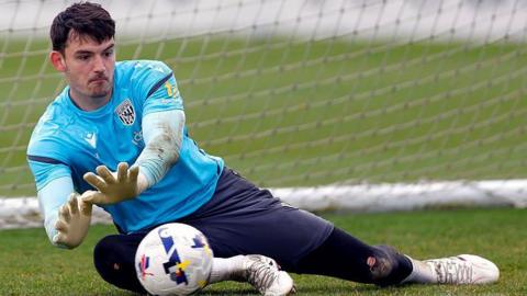 Max O'Leary dives to save the ball during a training session for West Bromwich Albion