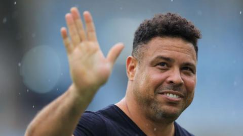 A smiling Ronaldo waves to the crowd