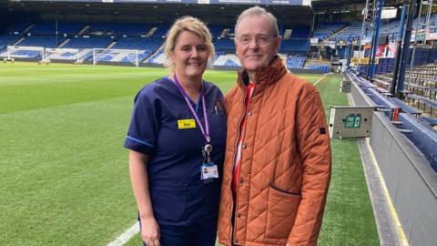 Sue Collins with Paul Rodell on the pitch at Kenilworth Road