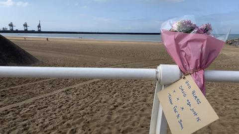Tribute flowers at the beach