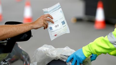 Self testing kits are collected after use at a coronavirus test site in Poole, following the outbreak of the coronavirus disease (COVID-19), Poole, Britain, May 2, 2020