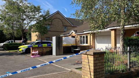 A police cordon outside a property on Cwm Du Close in the Gendros area of Swansea